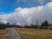 Snow squall clouds pass to the north and east of the Breeding Barn at Shelburne Farms yesterday at midday.